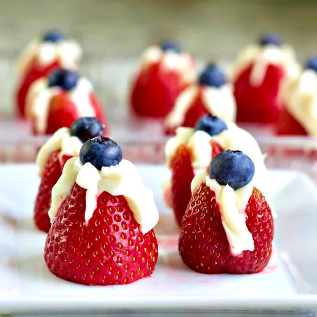 Strawberries filled with sweet creamcheese and topped with a blueberry
