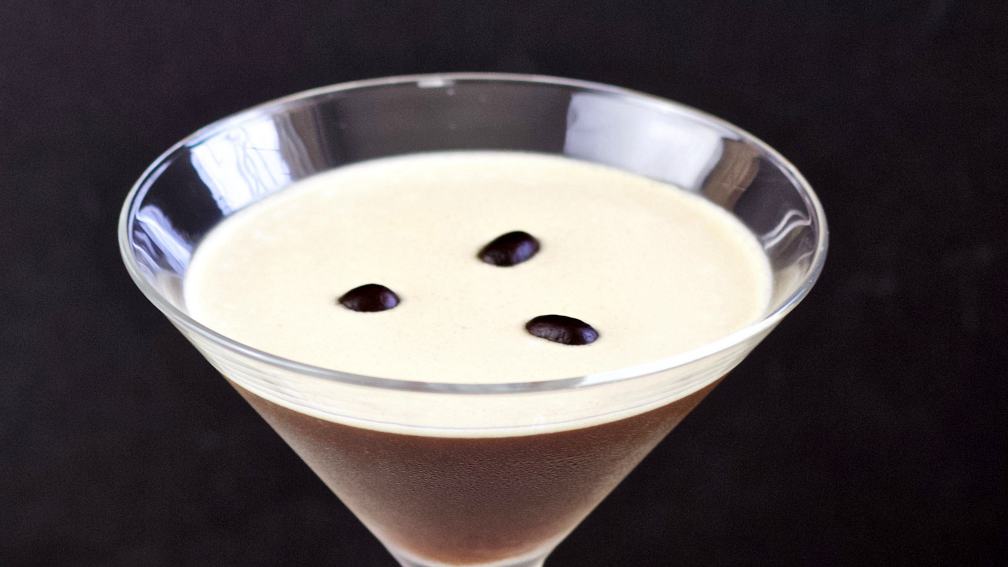 espresso martini with three coffee beans on top.