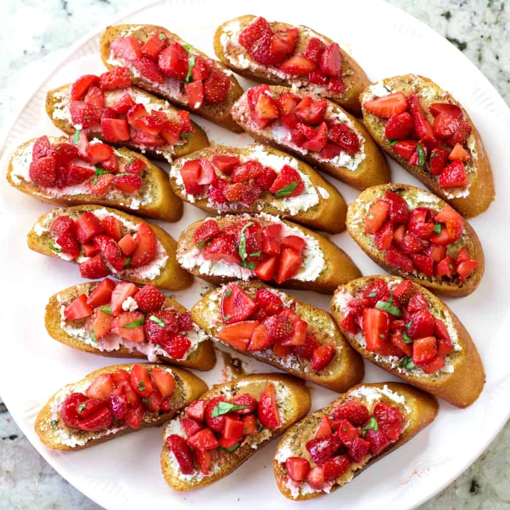 a tray full of strawberry basil bruschetta