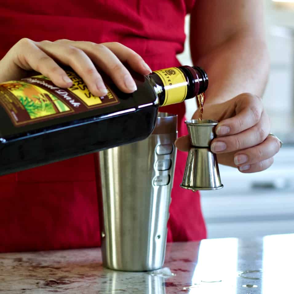 pouring the jamaican rum for rum punch