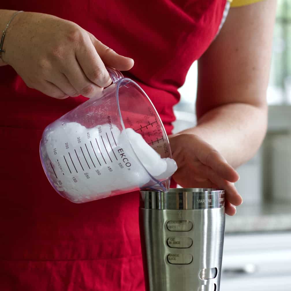 filling a cocktail shaker with ice