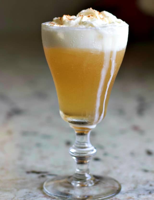 Caramel Vanilla Cream Soda Cocktail with whipped cream running down the sides