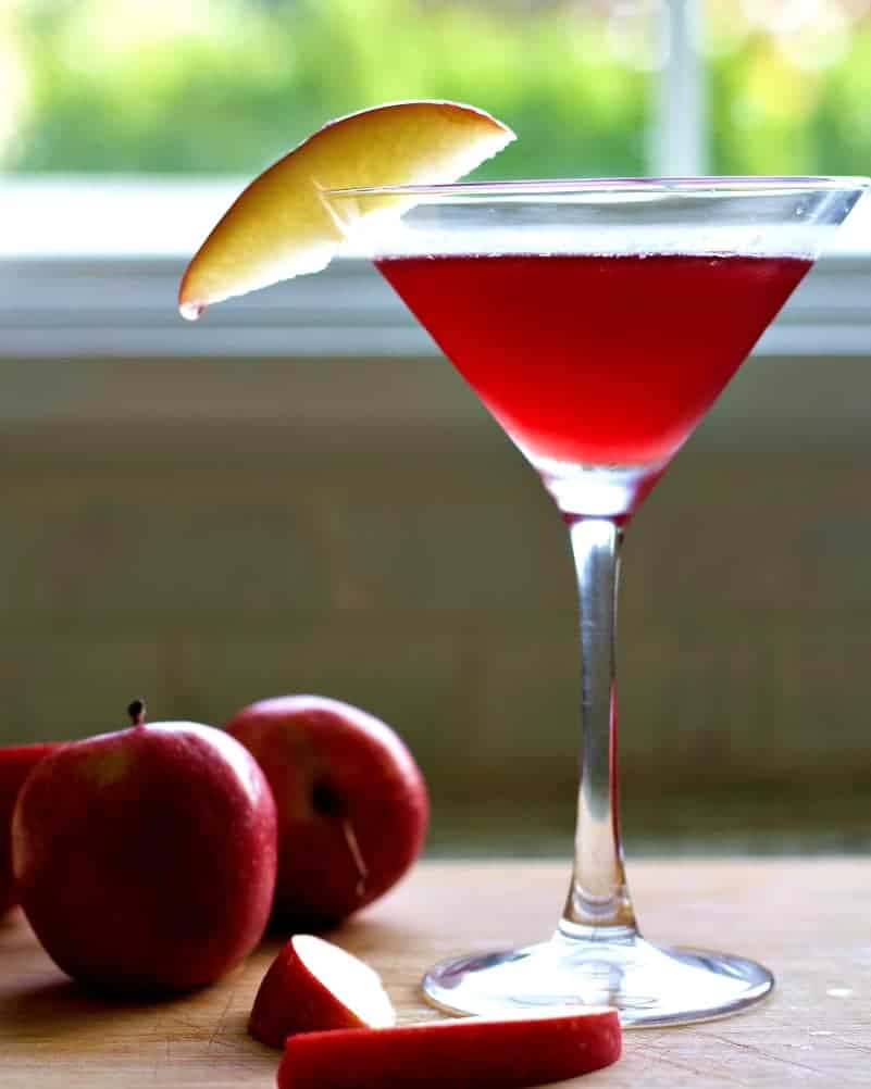 White Cranberry Mimosa Recipe with Rosemary 8 Garnished Washington Apple Drink with apples on a wooden board.