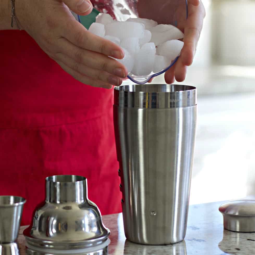 adding ice to cocktail shaker
