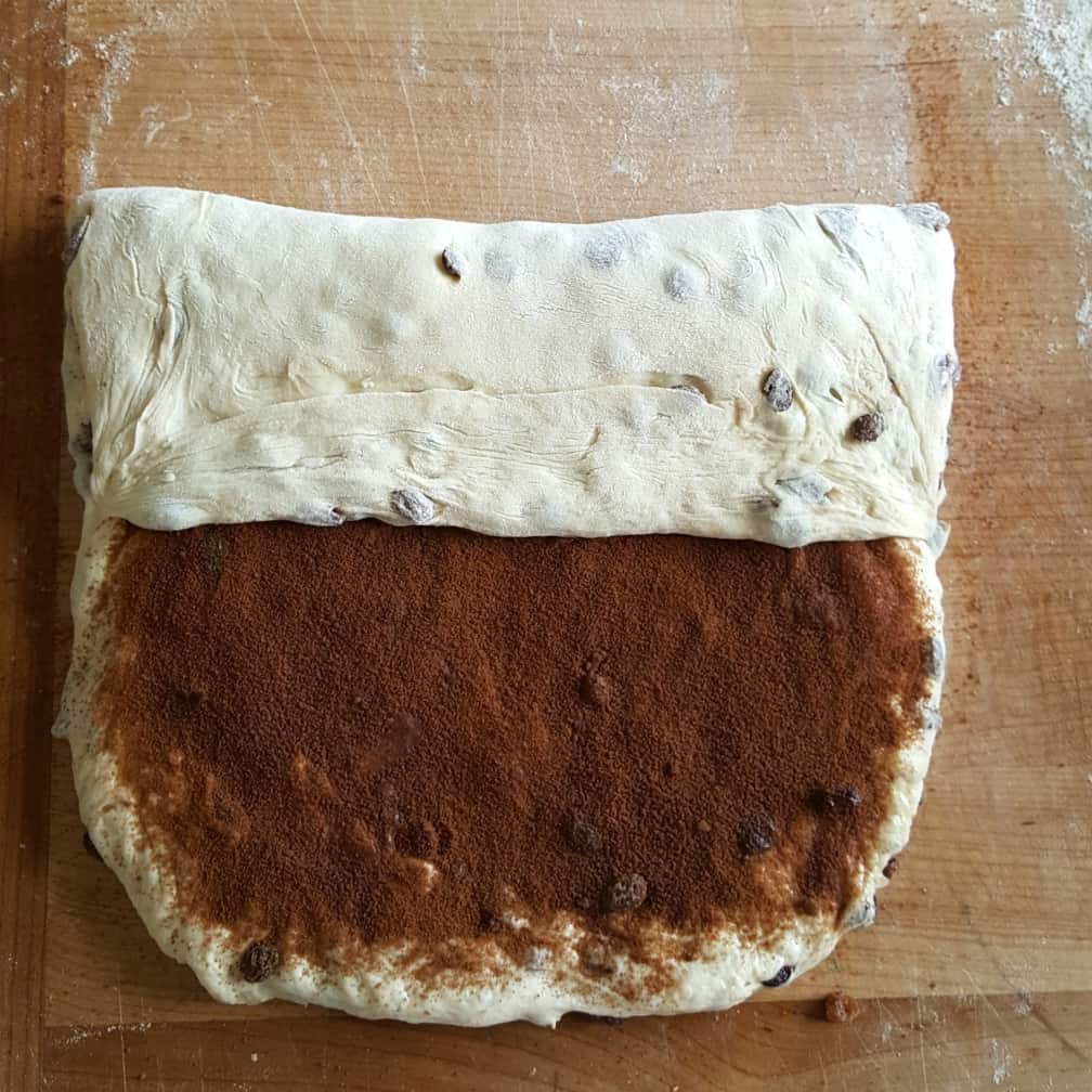 preparing to roll the filing up. cinnamon raisin bread