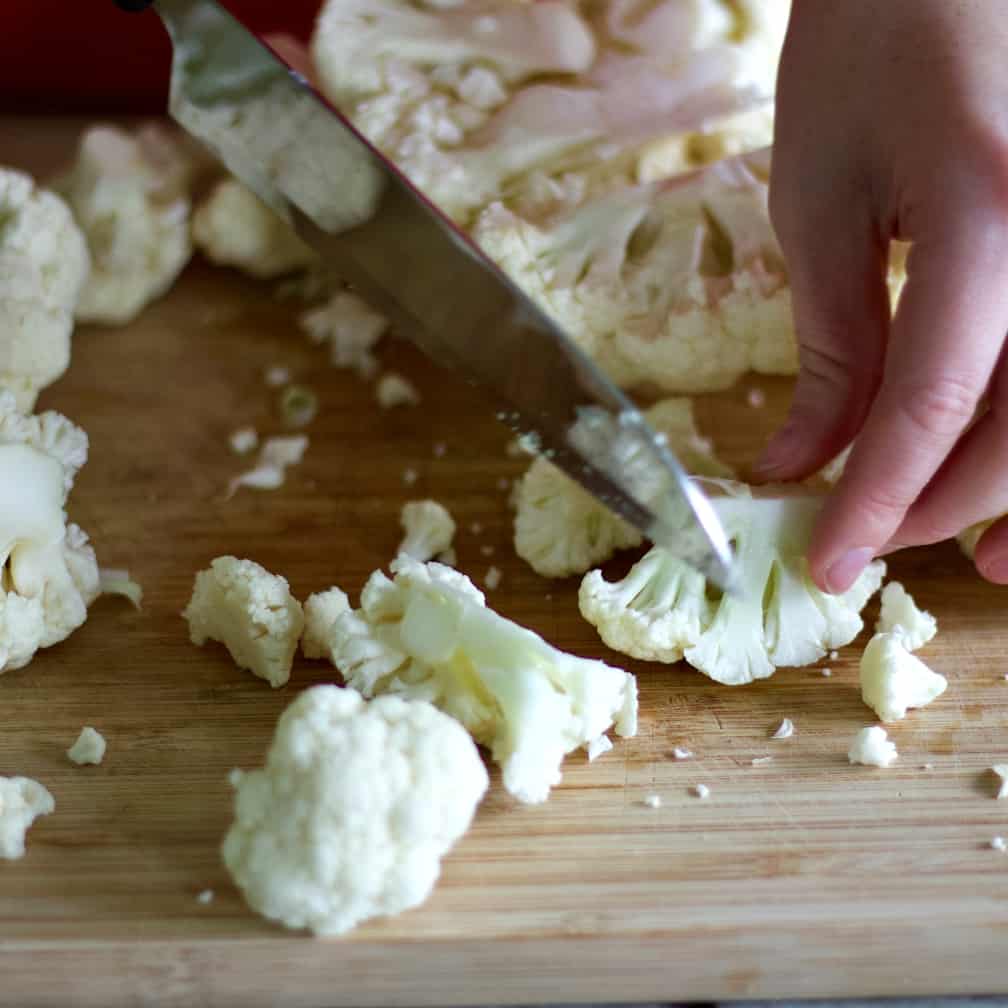 Cutting cauliflower into small florets