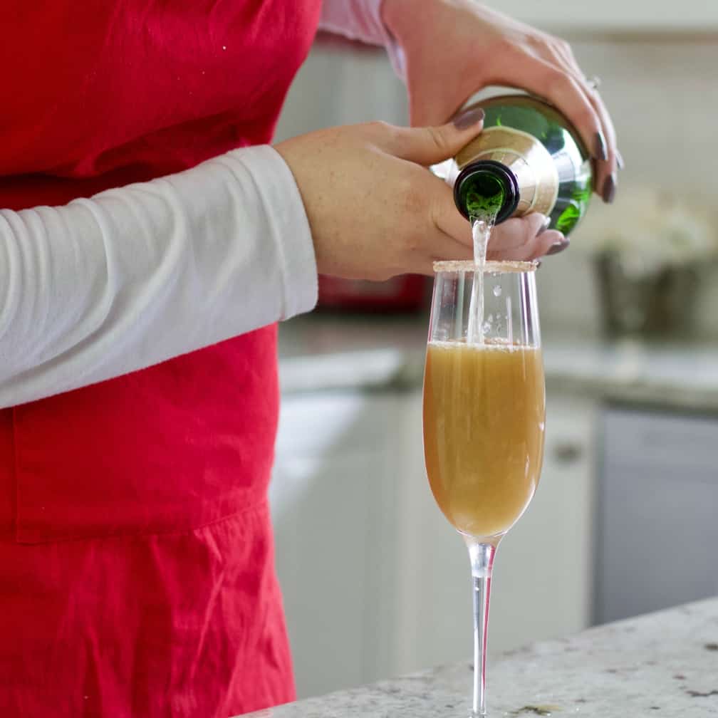pouring champagne into pear juice