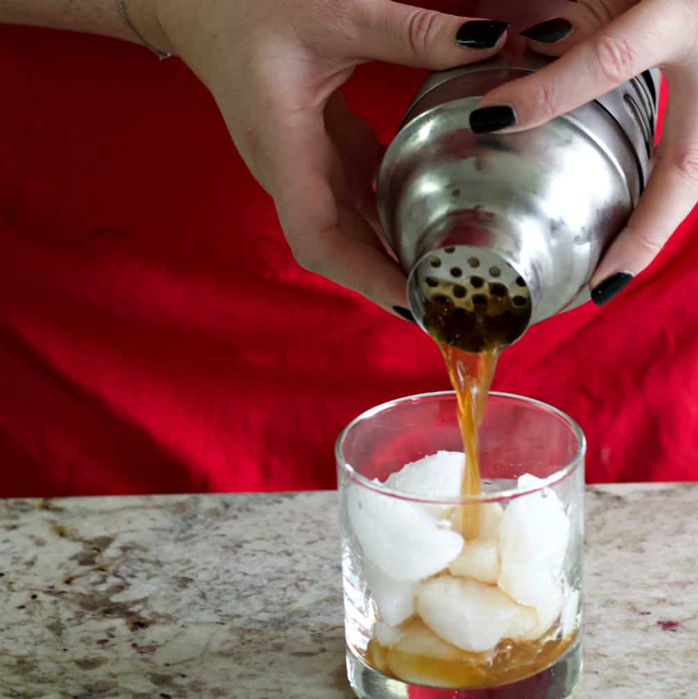 strain the twisted black russian into glass