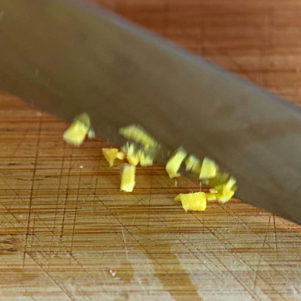 chopping fresh ginger root
