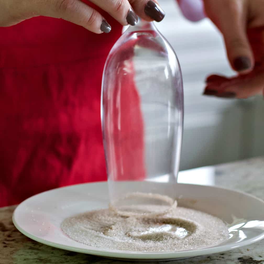 champagne flute inverted into cinnamon sugar mix.