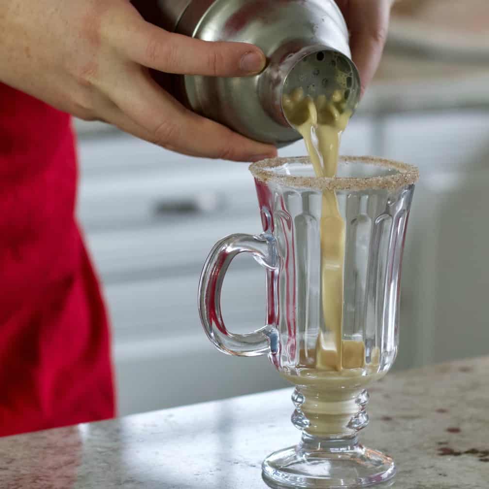 pouring an eggnog cocktail
