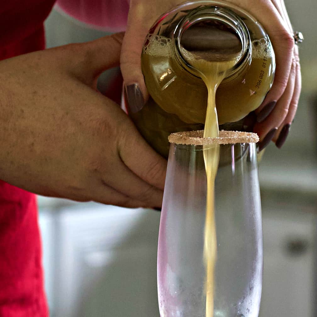 pouring pear juice into glass
