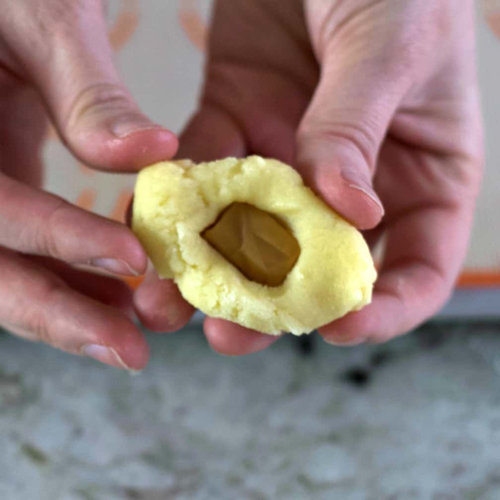 adding caramels to sugar cookie dough