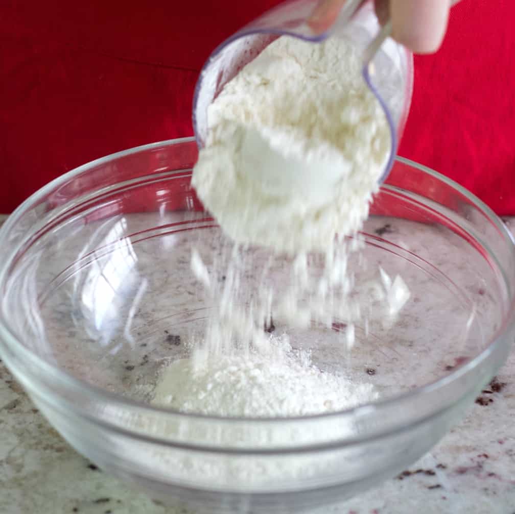 pouring flour into mixing bowl for puff pastry