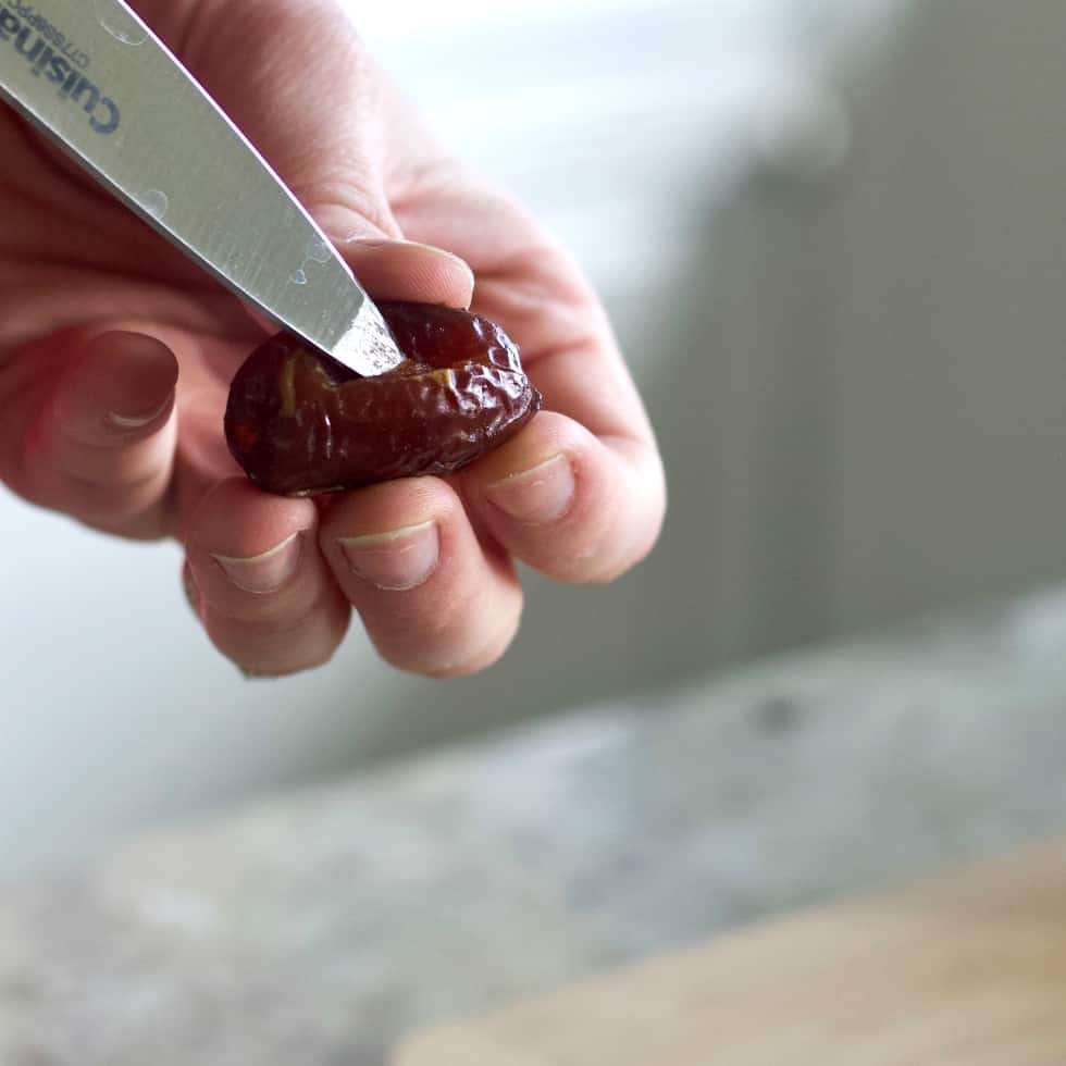 cutting open a date to stuff