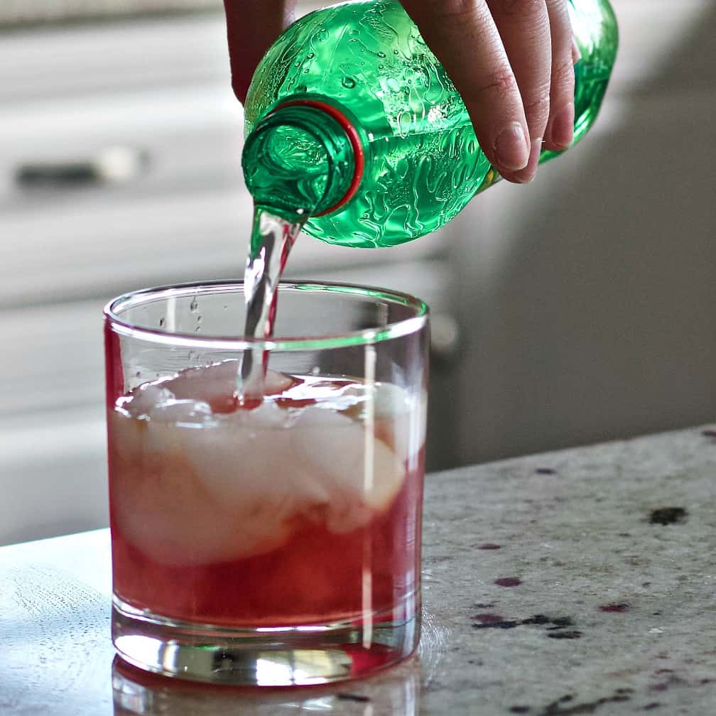 Pouring 7up into drink