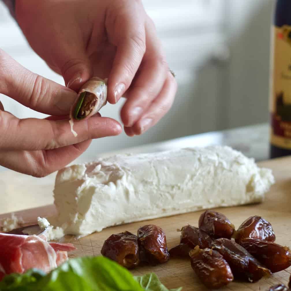 wrap prosciutto around basil leaf.