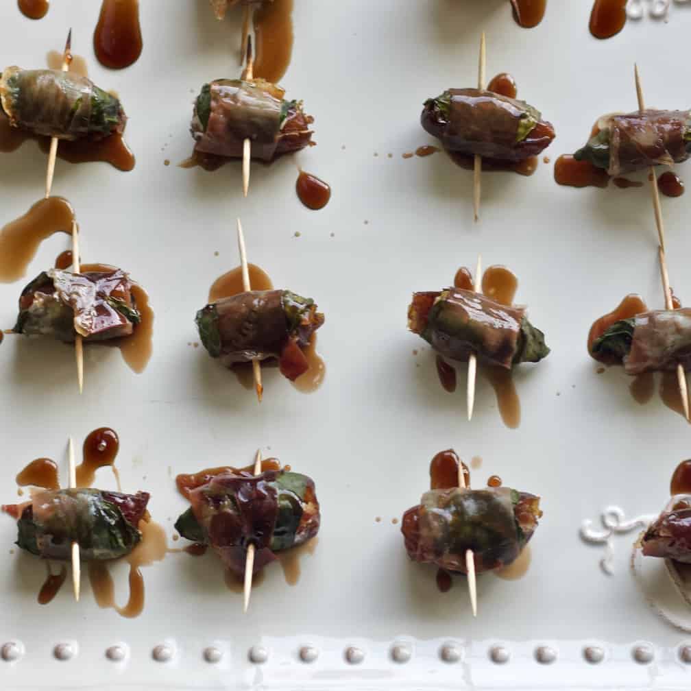 wrapped stuffed dates-baked on party tray.