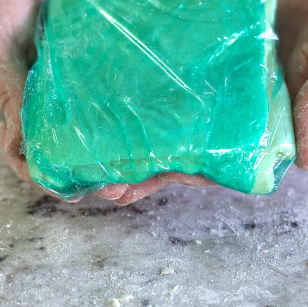 puff pastry wrapped in green plastic wrap.