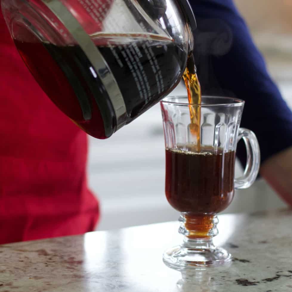 Pouring hot coffee to make a Mexican Coffee.