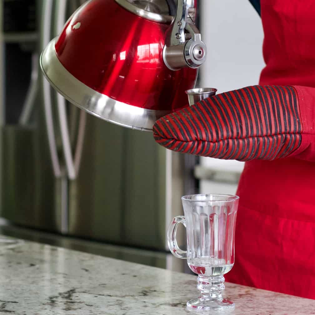 making hot buttered rum-pouring hot water