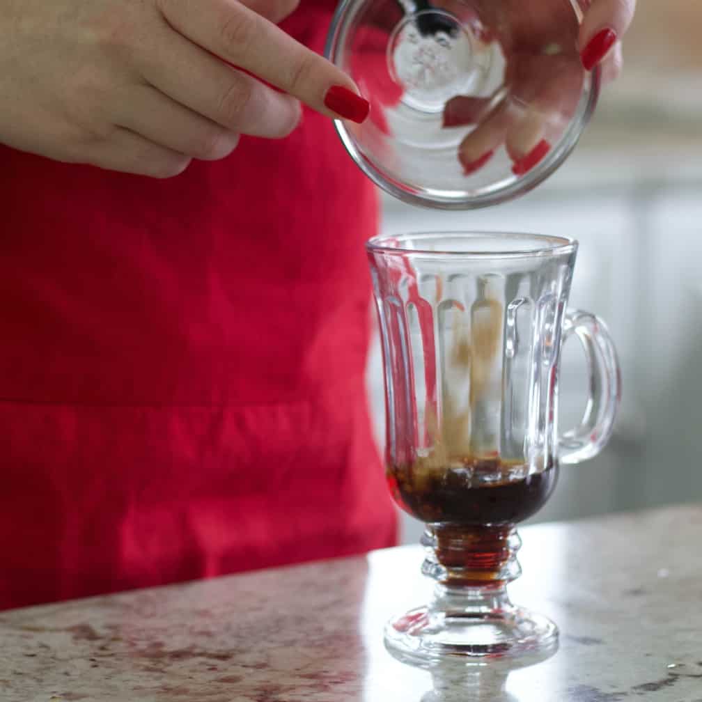 Pouring brown sugar into mug-Mexican coffee