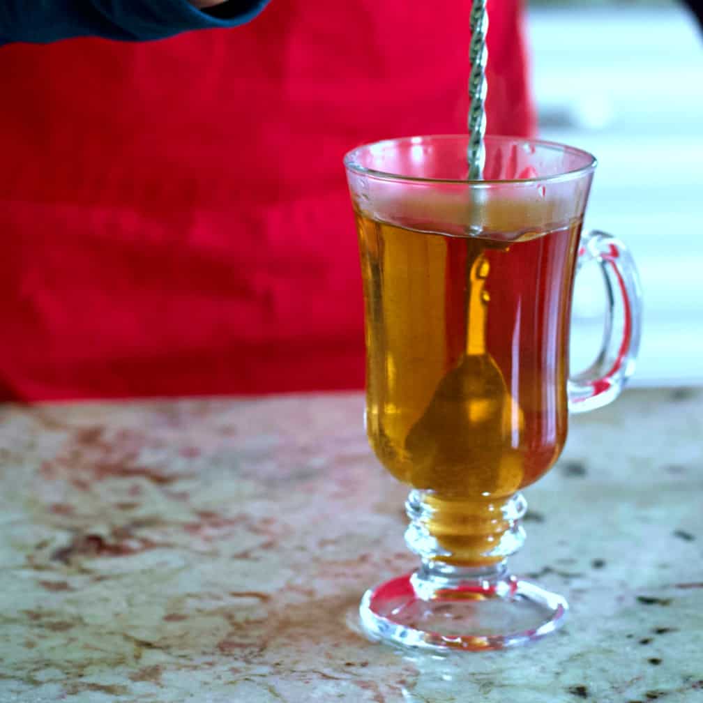 stirring a hot buttered rum