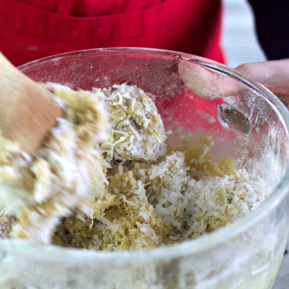 stirring coconut into almond joy cookie dough