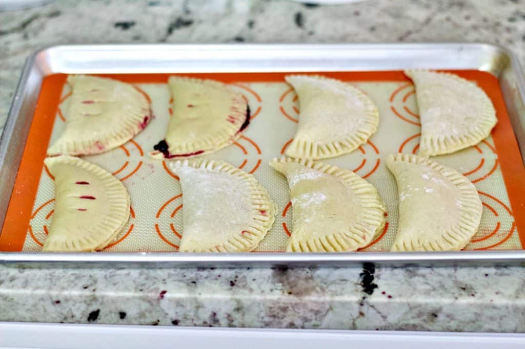 unbaked hand pies on baking sheet.