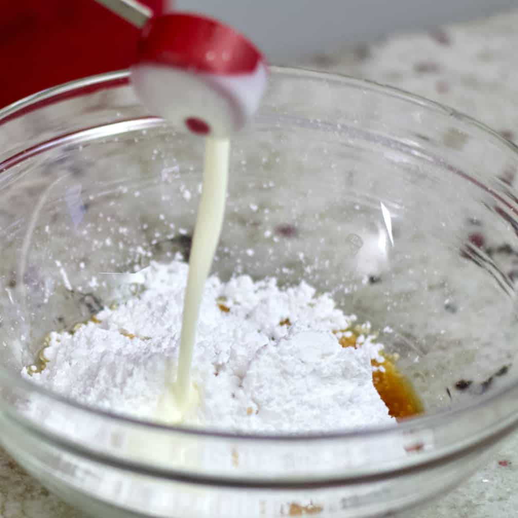 pouring heavy cream into bowl.