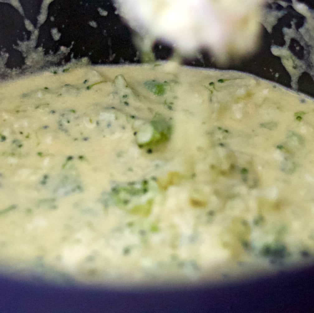 stirring broccoli cheese soup