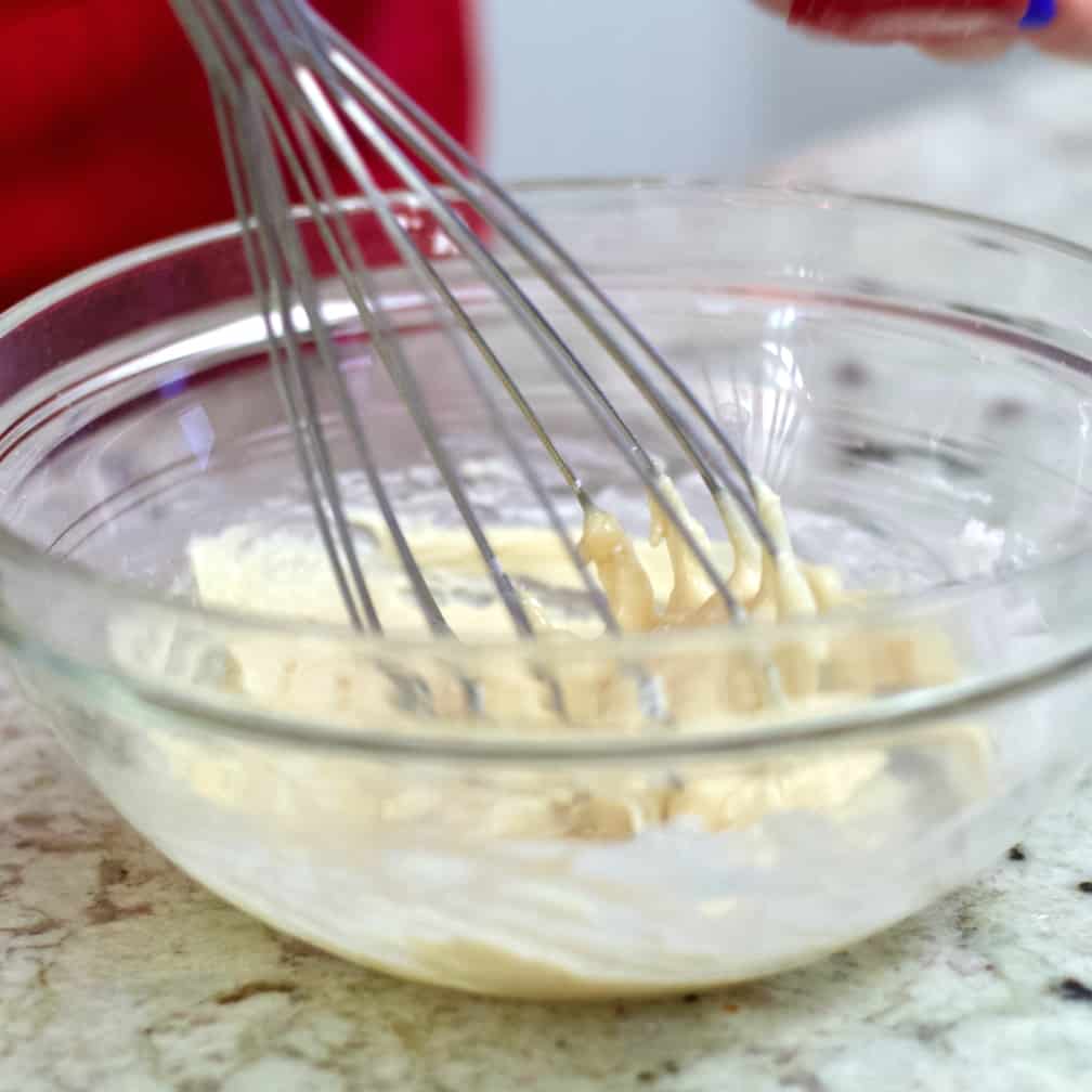 mixing powdered sugar glaze.