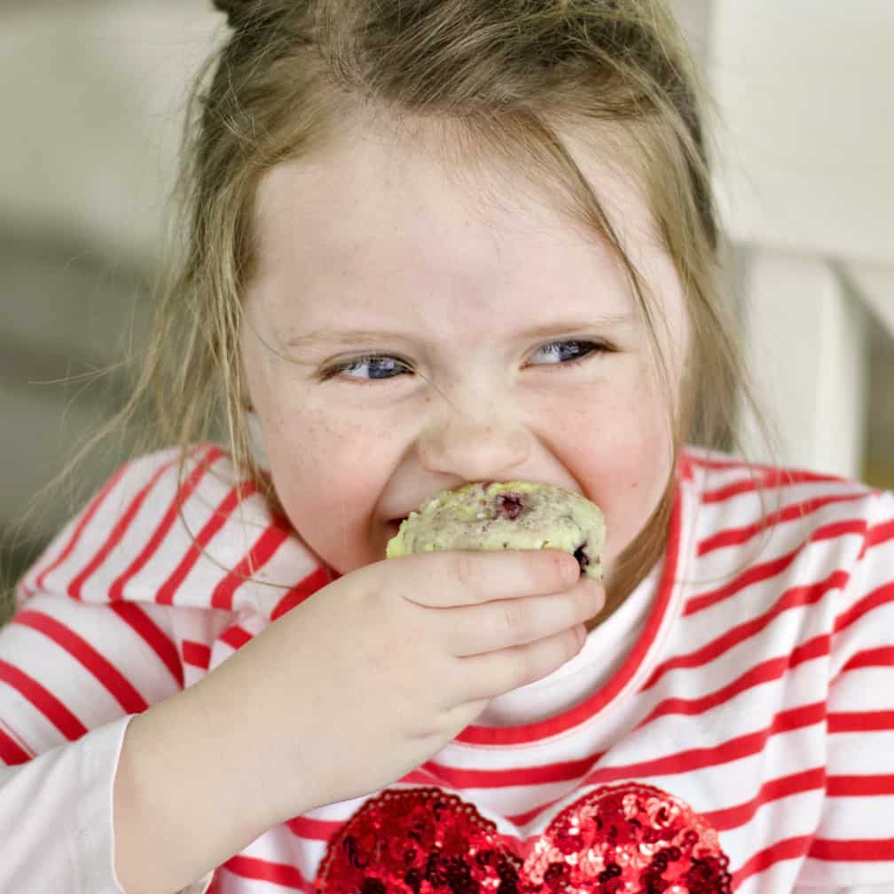 Child eating lemon blueberry muffins