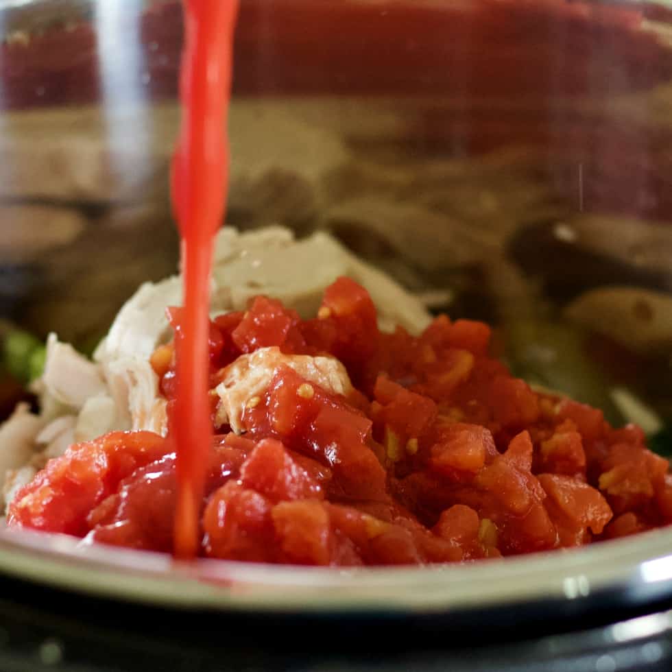 pouring tomato sauce into the instant pot