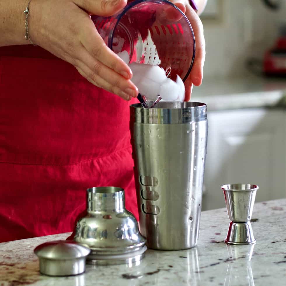 Pouring ice into shaker-bacardi cocktail