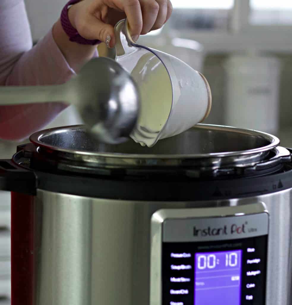 pouring cream into this keto soup recipe