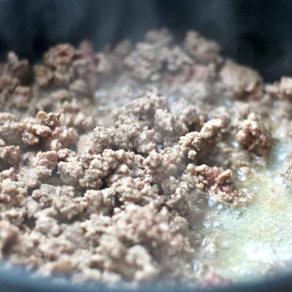 Ground beef browning in a skillet