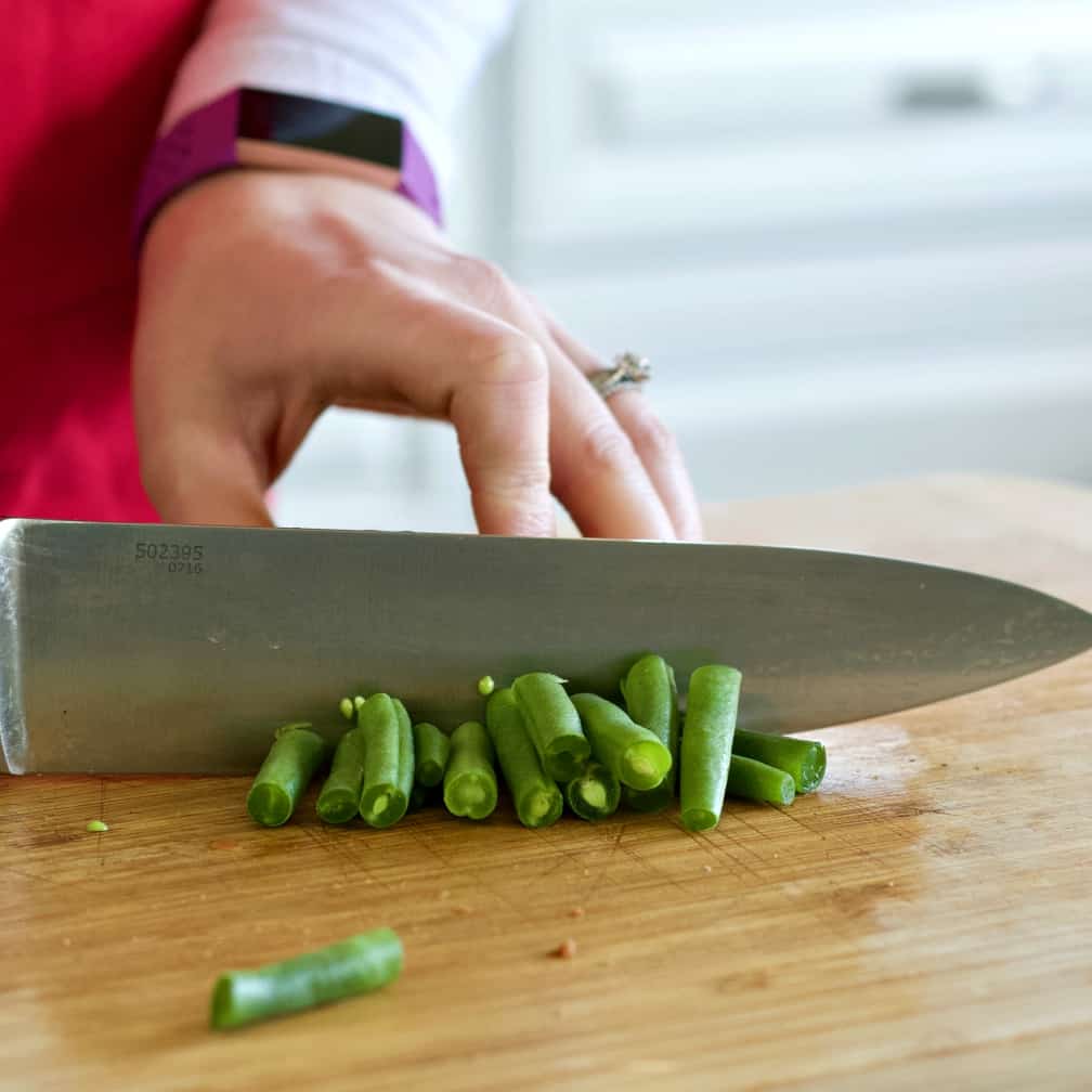 chopping fresh green beans-chicken vegetable soup