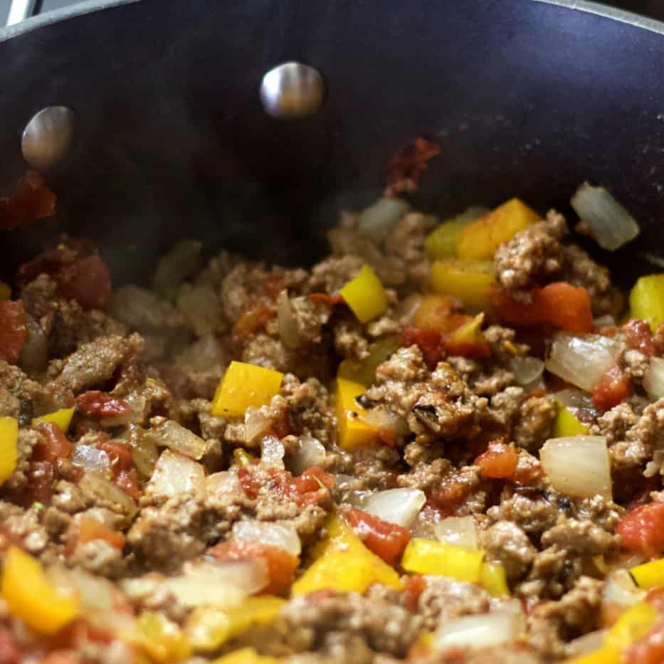 cooking onions peppers with hamburger