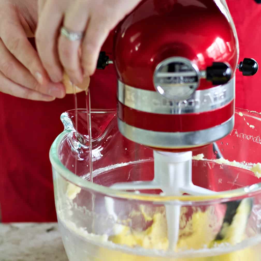 cracking eggs into muffin batter