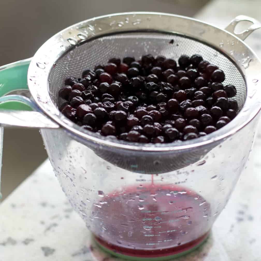 draining blueberries-lemon blueberry muffin recipe