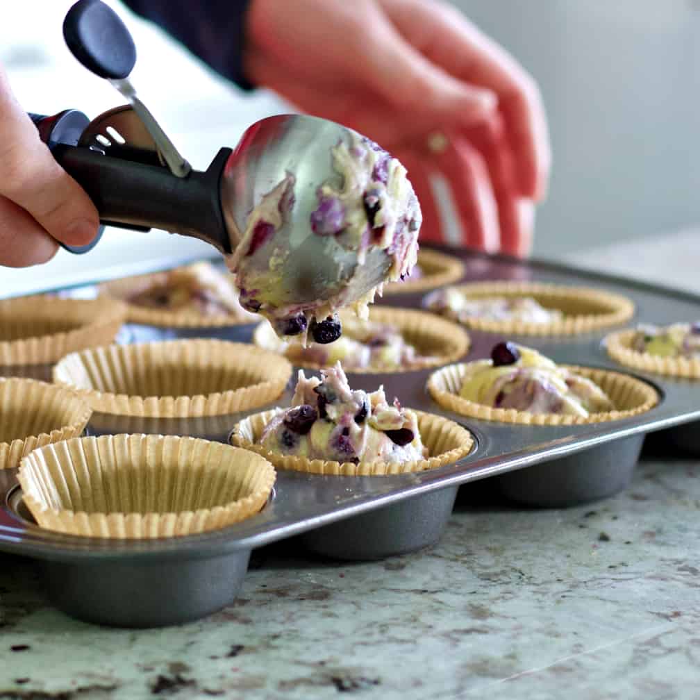 putting muffin dough into cupcake liners
