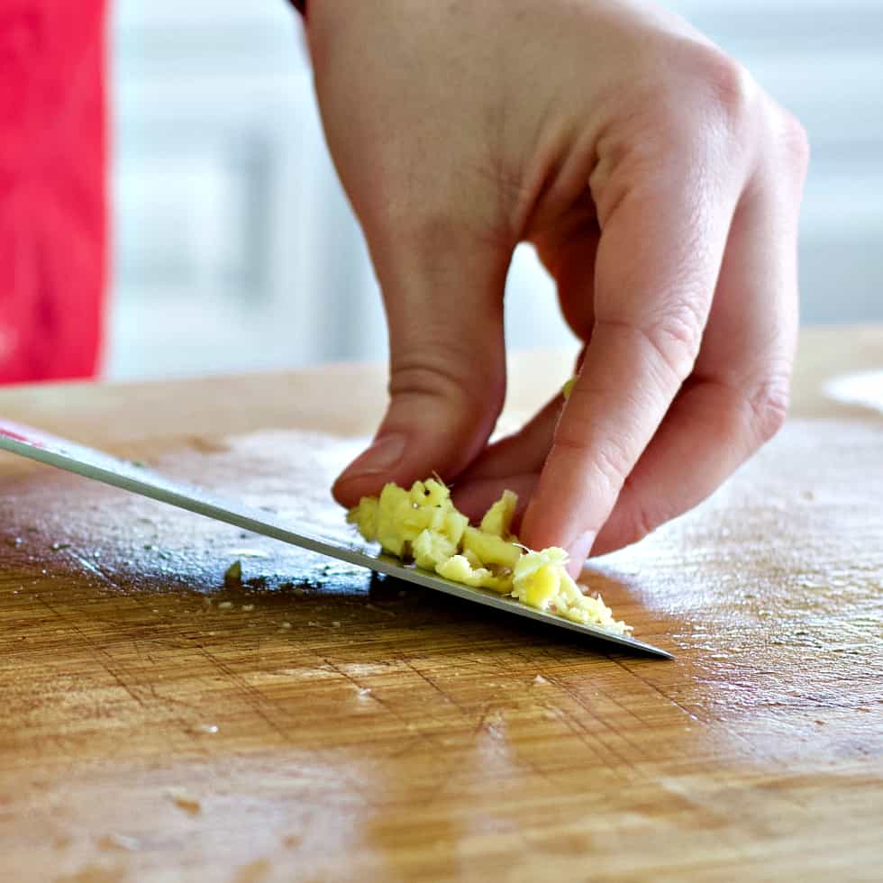 minced ginger on a knife-chicken soup recipe