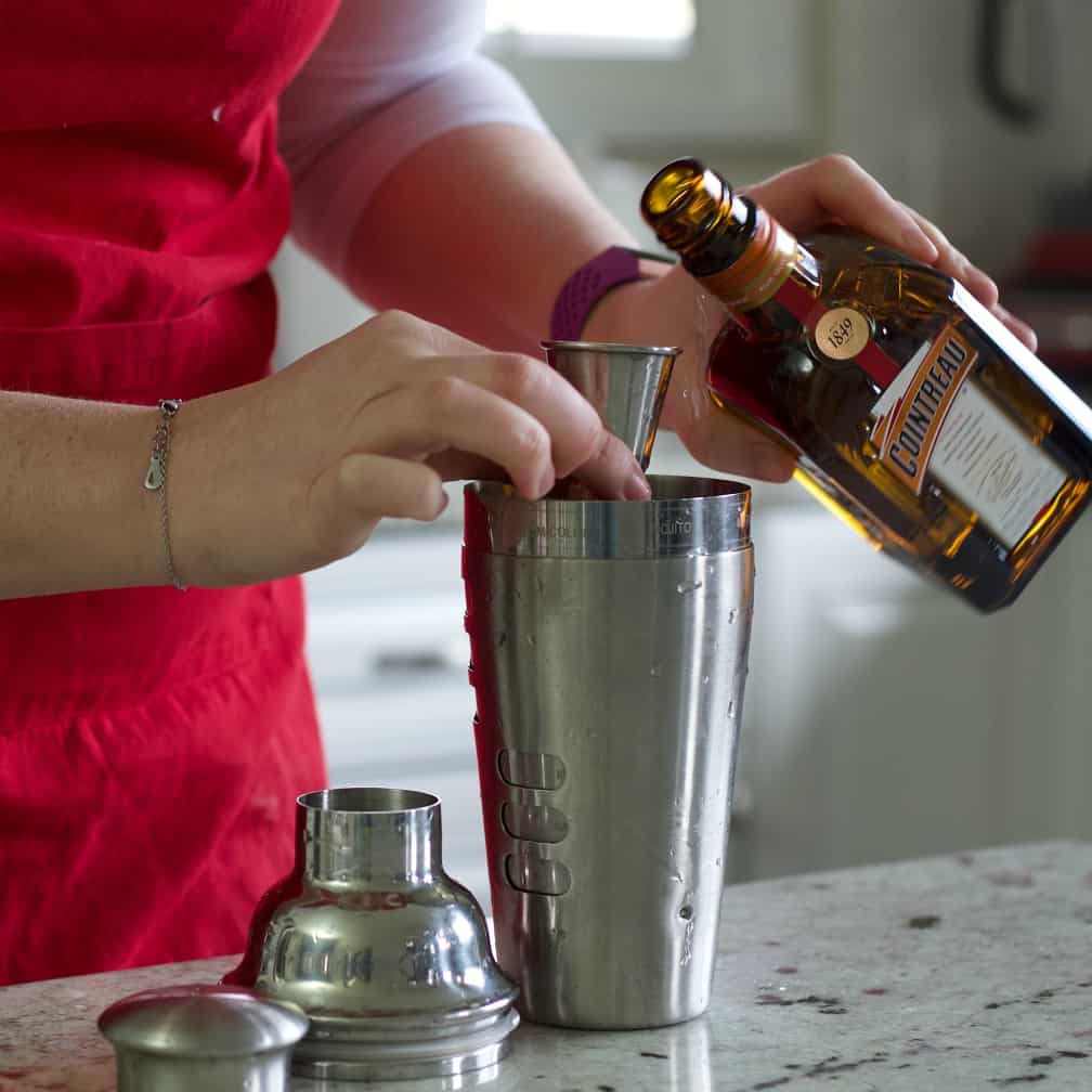 pouring Cointreau- Cosmo
