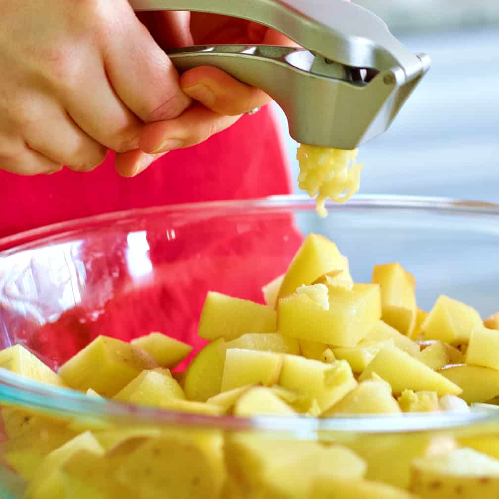 garlic in a garlic press-chicken soup 