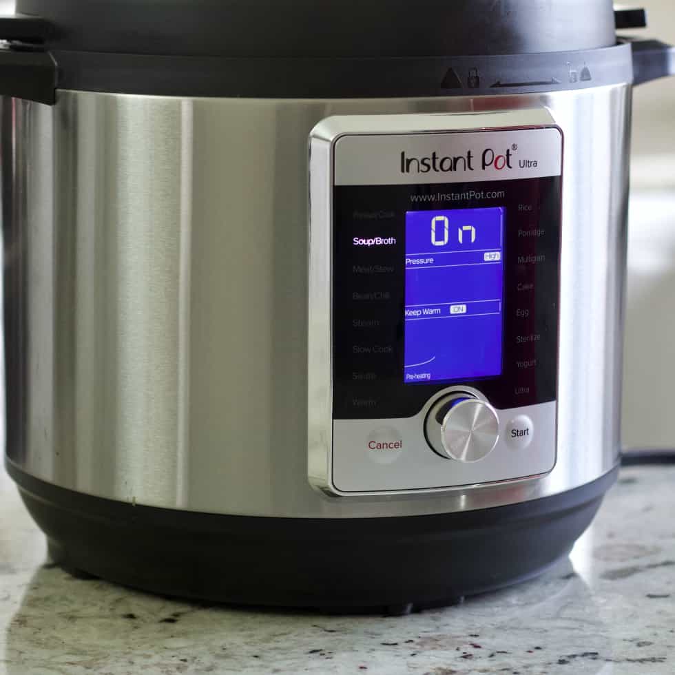 instant pot pot with soup function lighted.