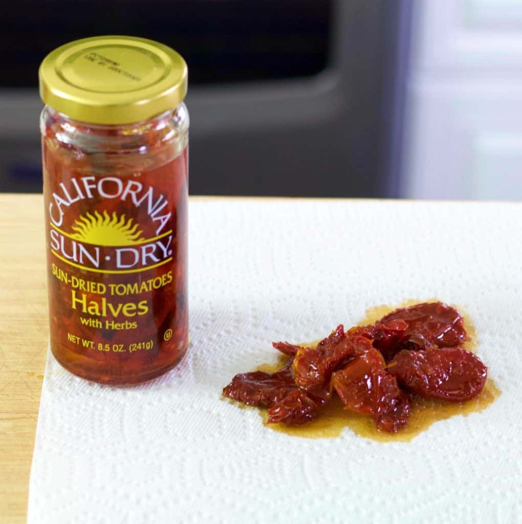 sun dried tomatoes and jar on a paper towel. Keto soup recipe