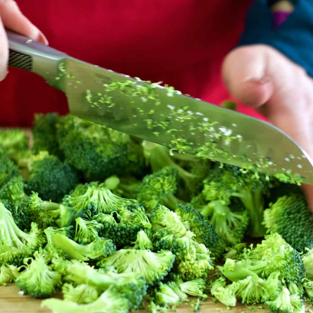 chopping broccoli into small pieces-chopped salad
