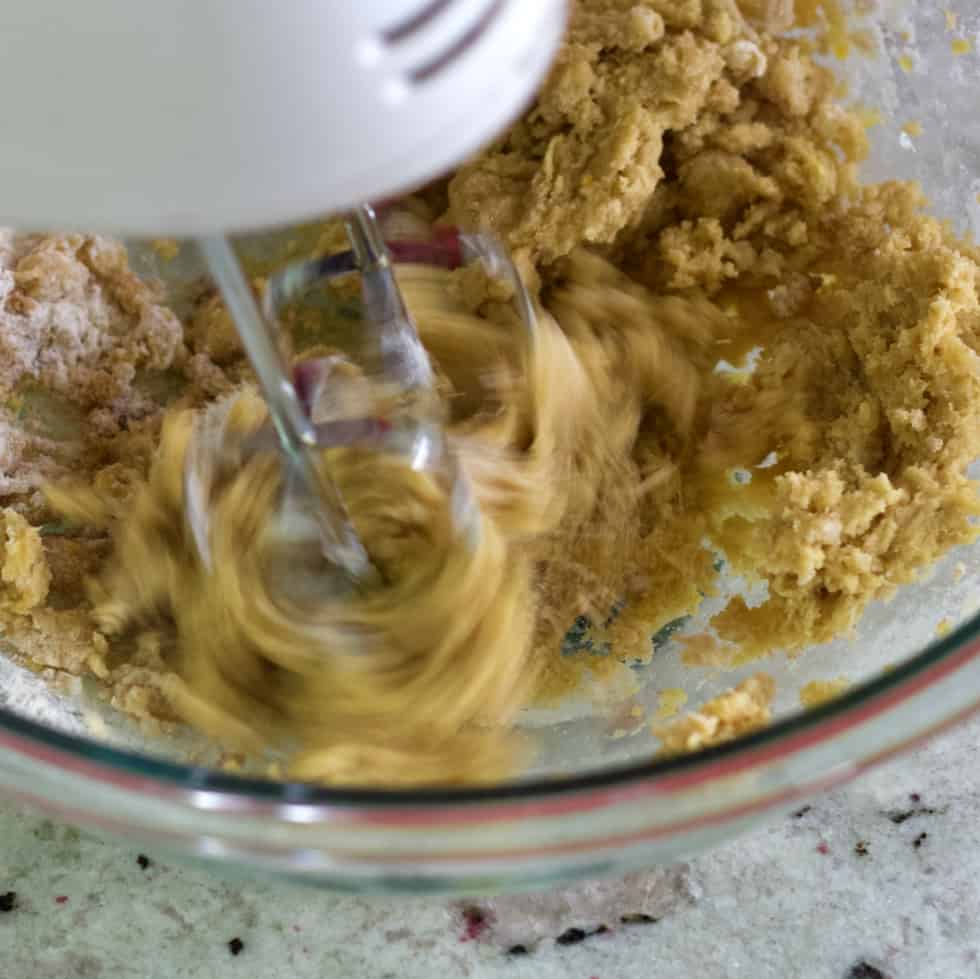 mixing lemon crust with an electric mixer.