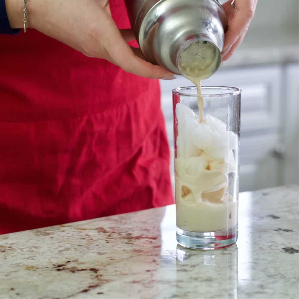 straining a cocktail-iced coffee